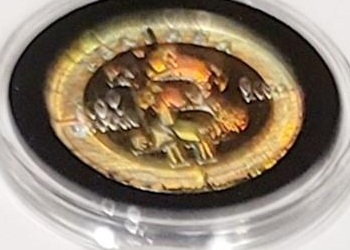 Design C — colored border with BTC tribal · Nickel-plated brass